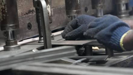 Hand-fitting a welded steel frame.