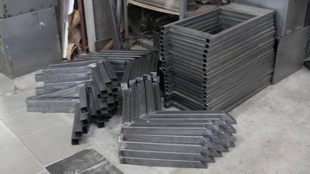 A batch of folded sheet-metal parts.